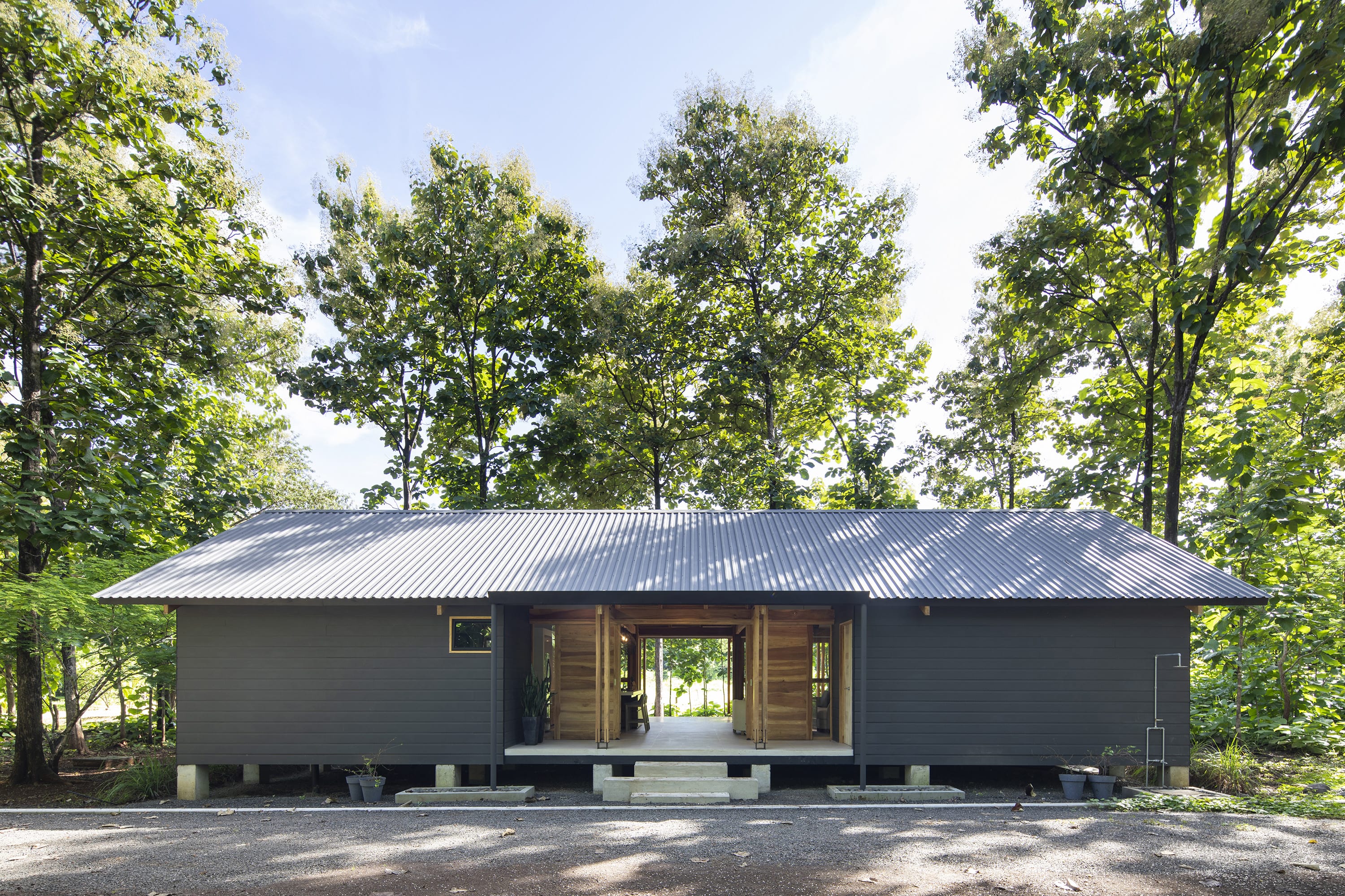 The Grey Wooden House Offers Tranquility within the Forest