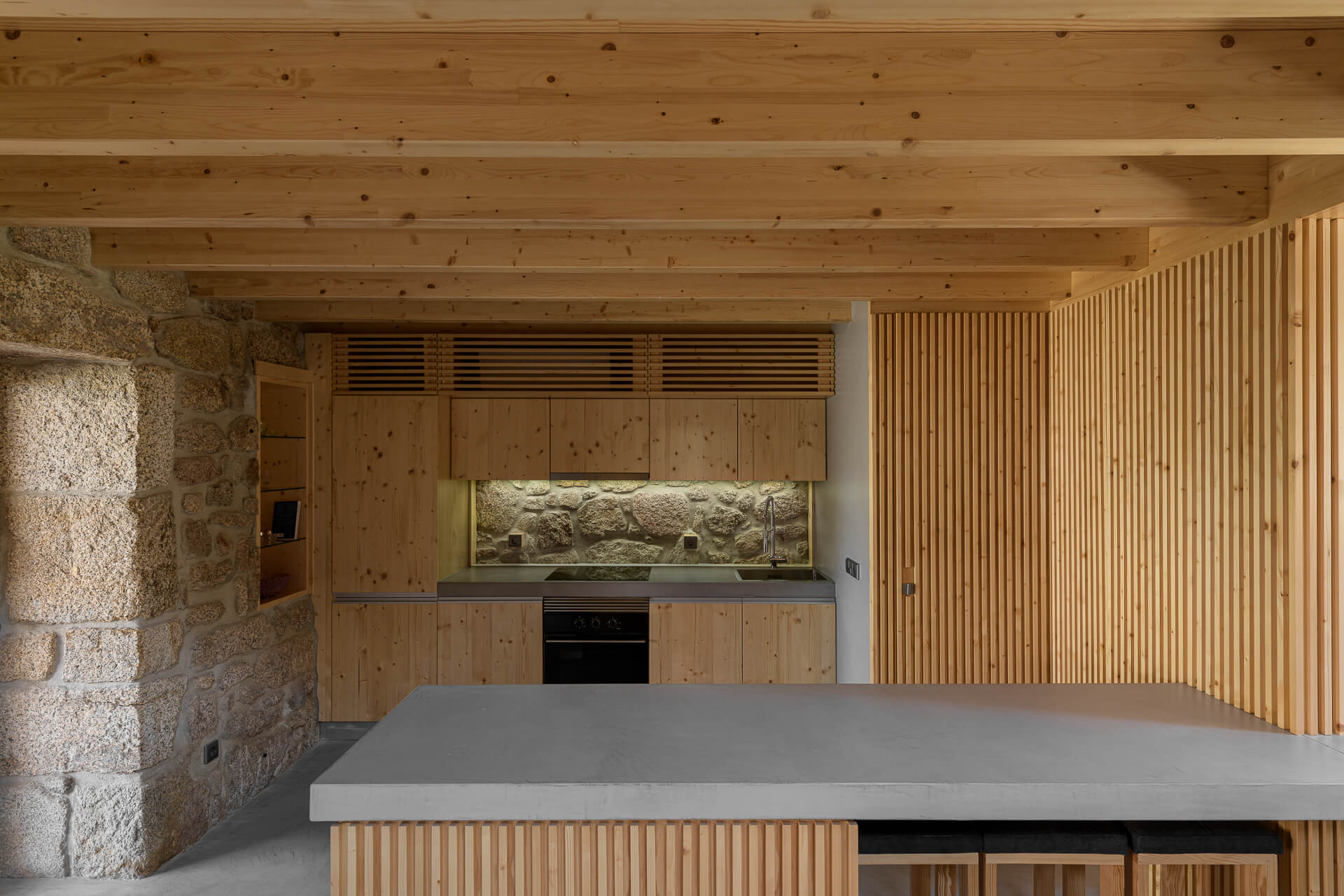 The kitchen area in the house is dominated by wood material