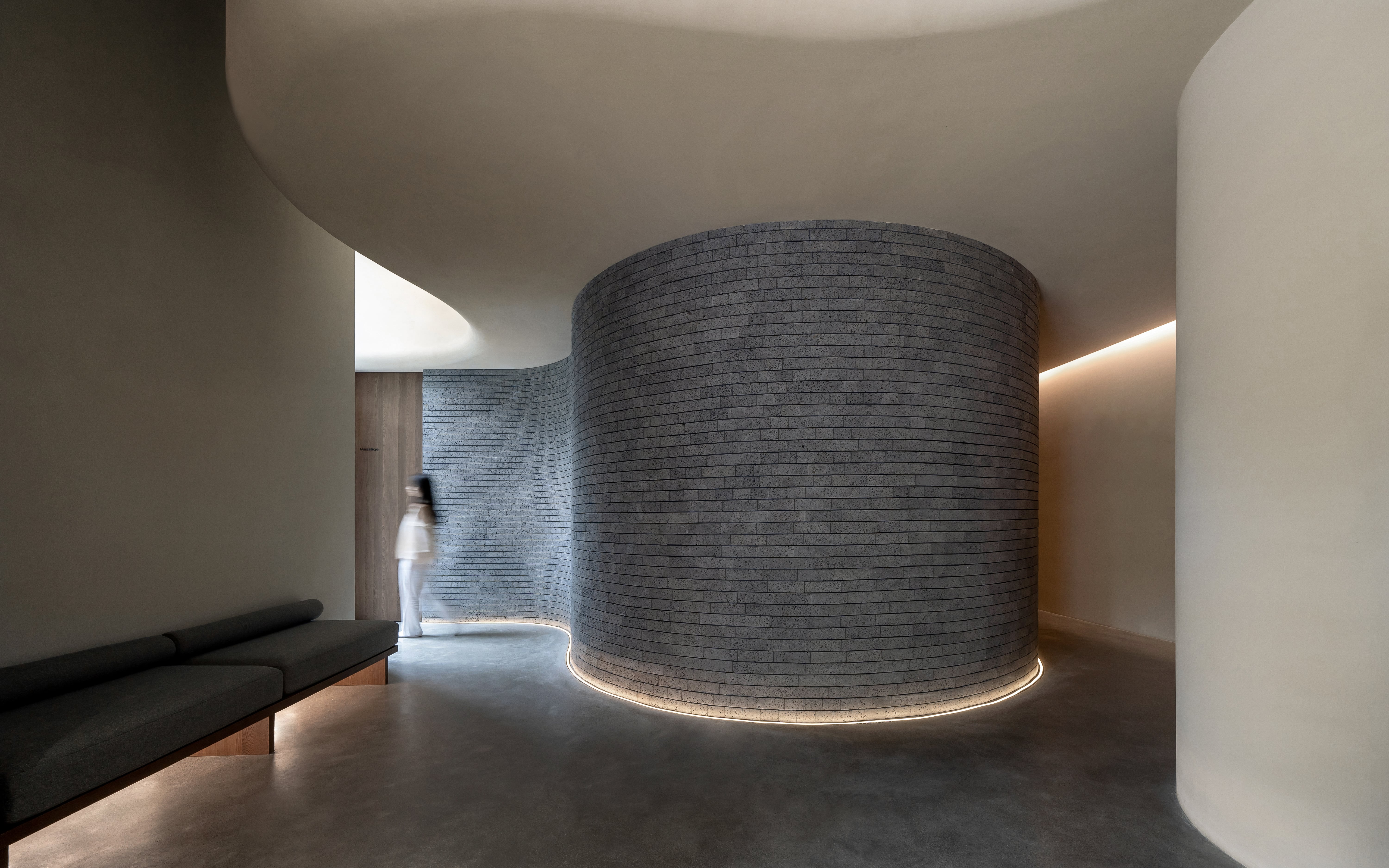 Smooth textures and curved walls dominate Shuran Wellness Space