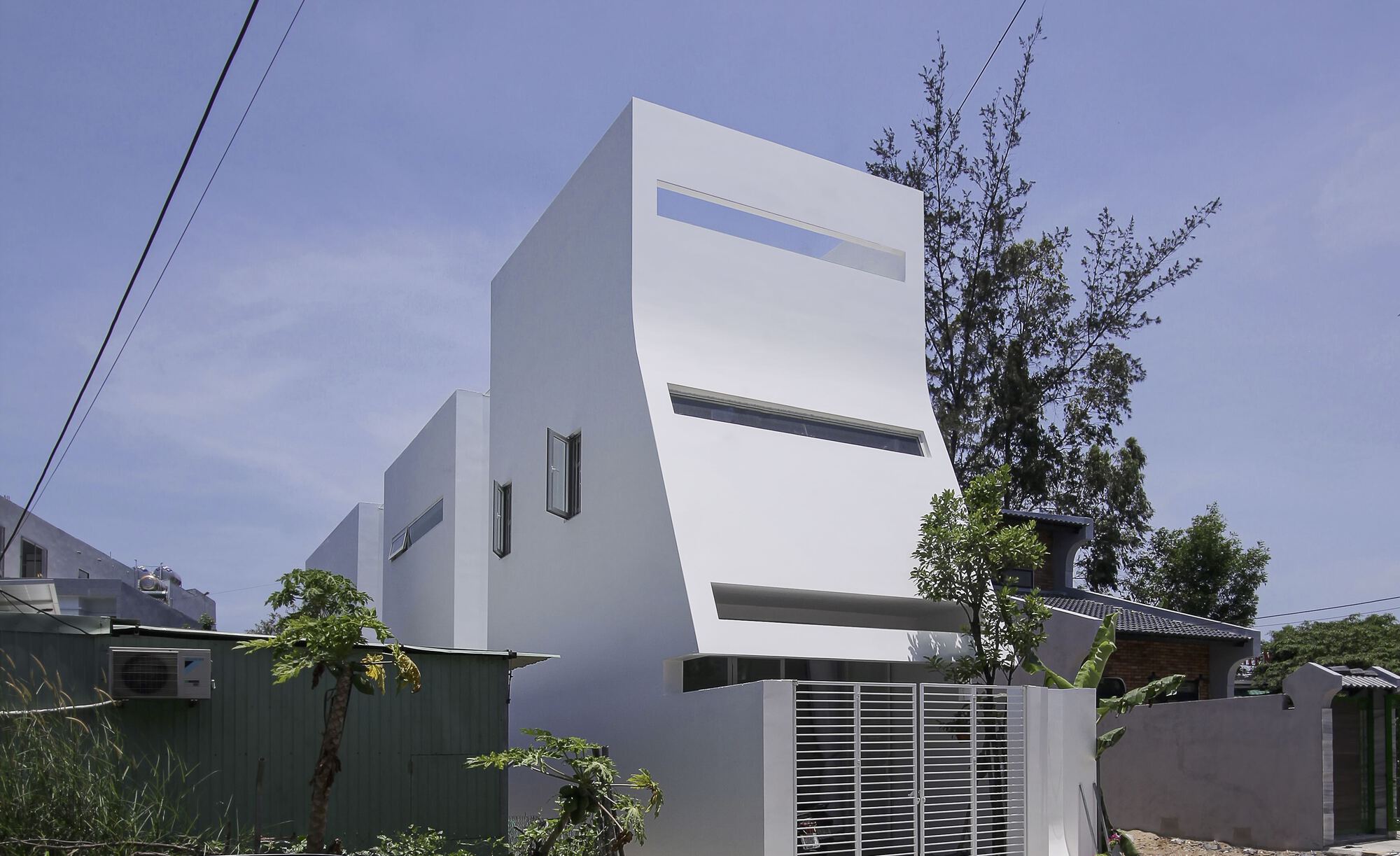 From the outside, the minimalist house has a 3-part structure