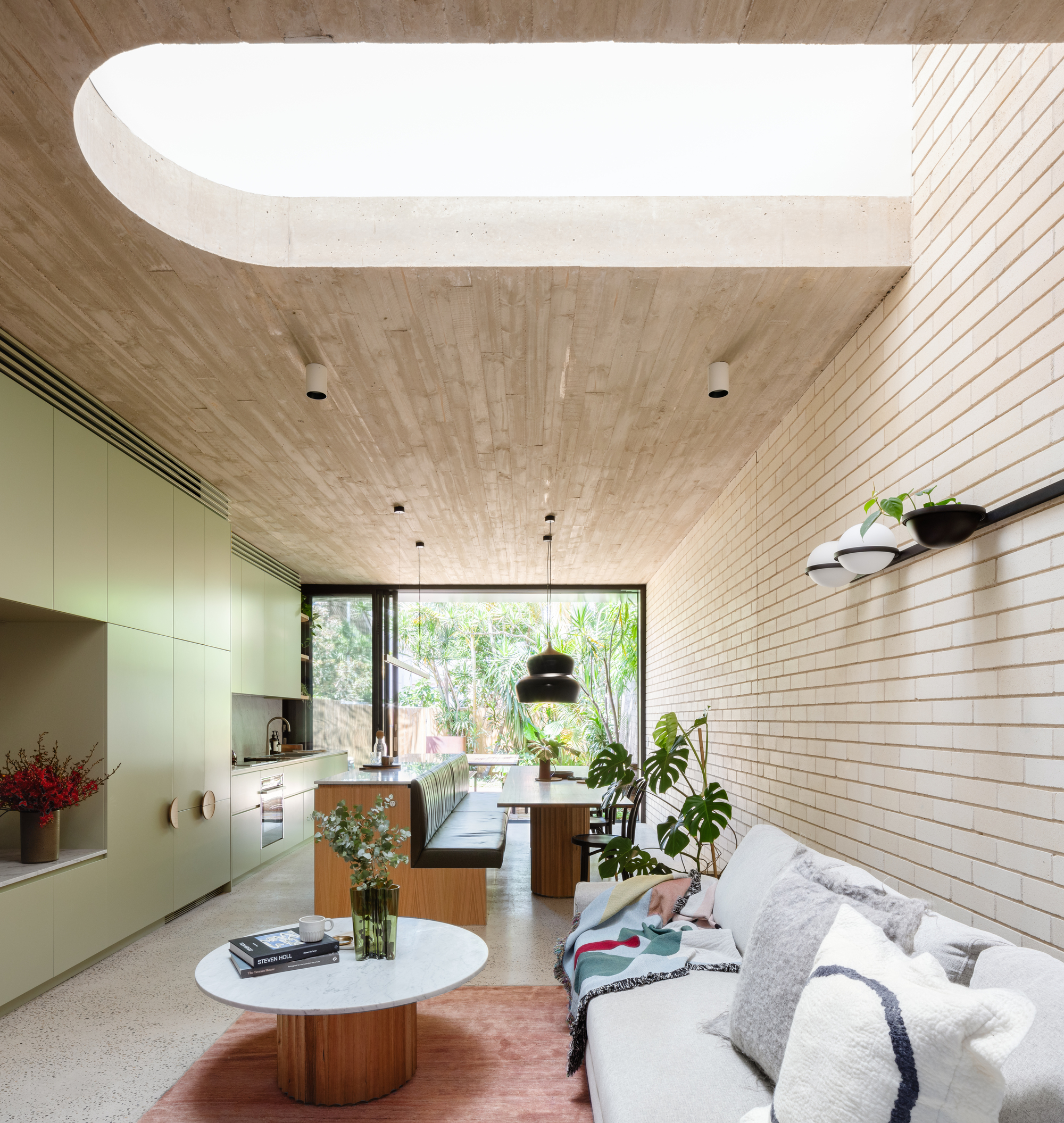 Natural light flooding concrete blonde through skylights and large glass doors