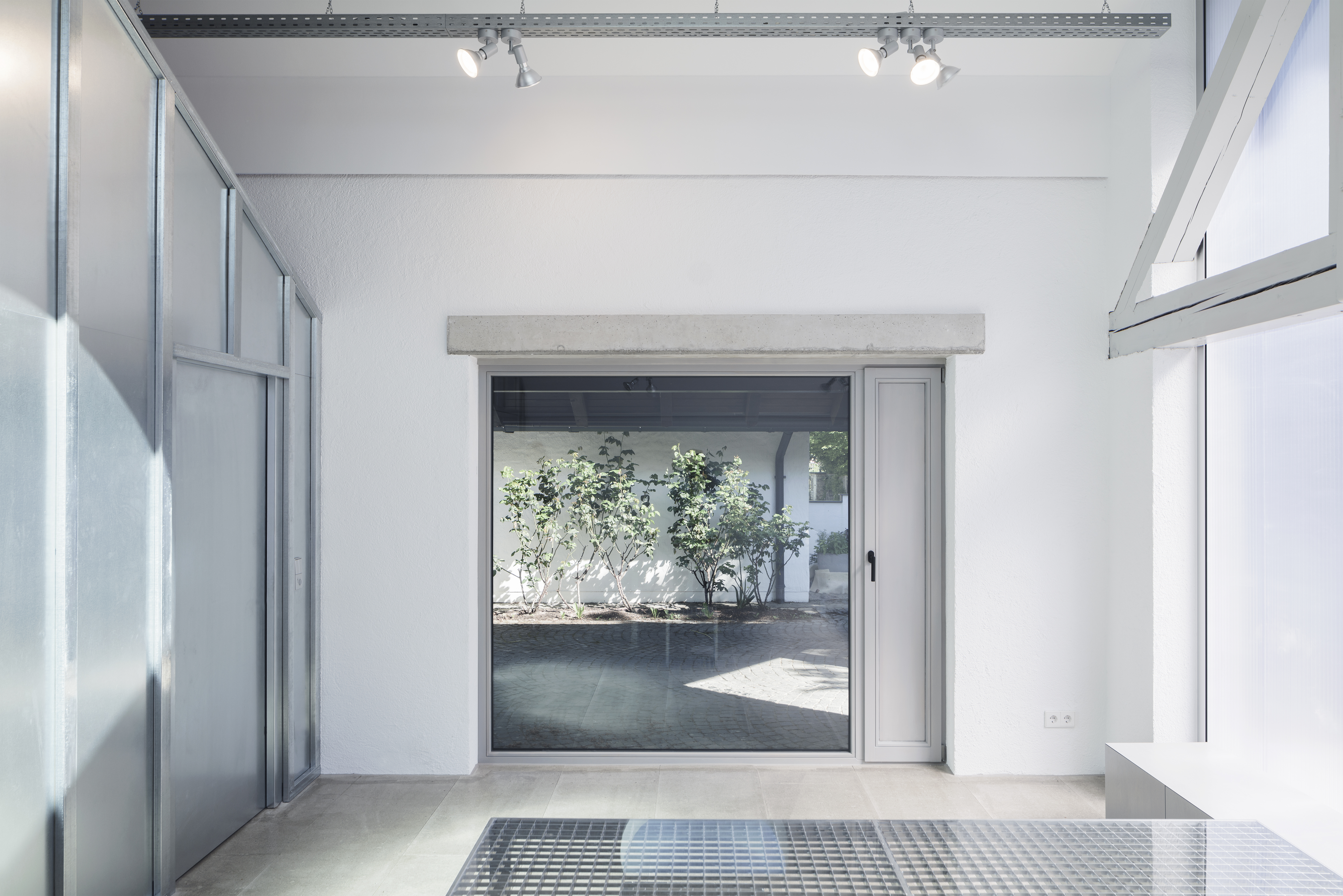 An opening that connects the space with the yard outside the garage