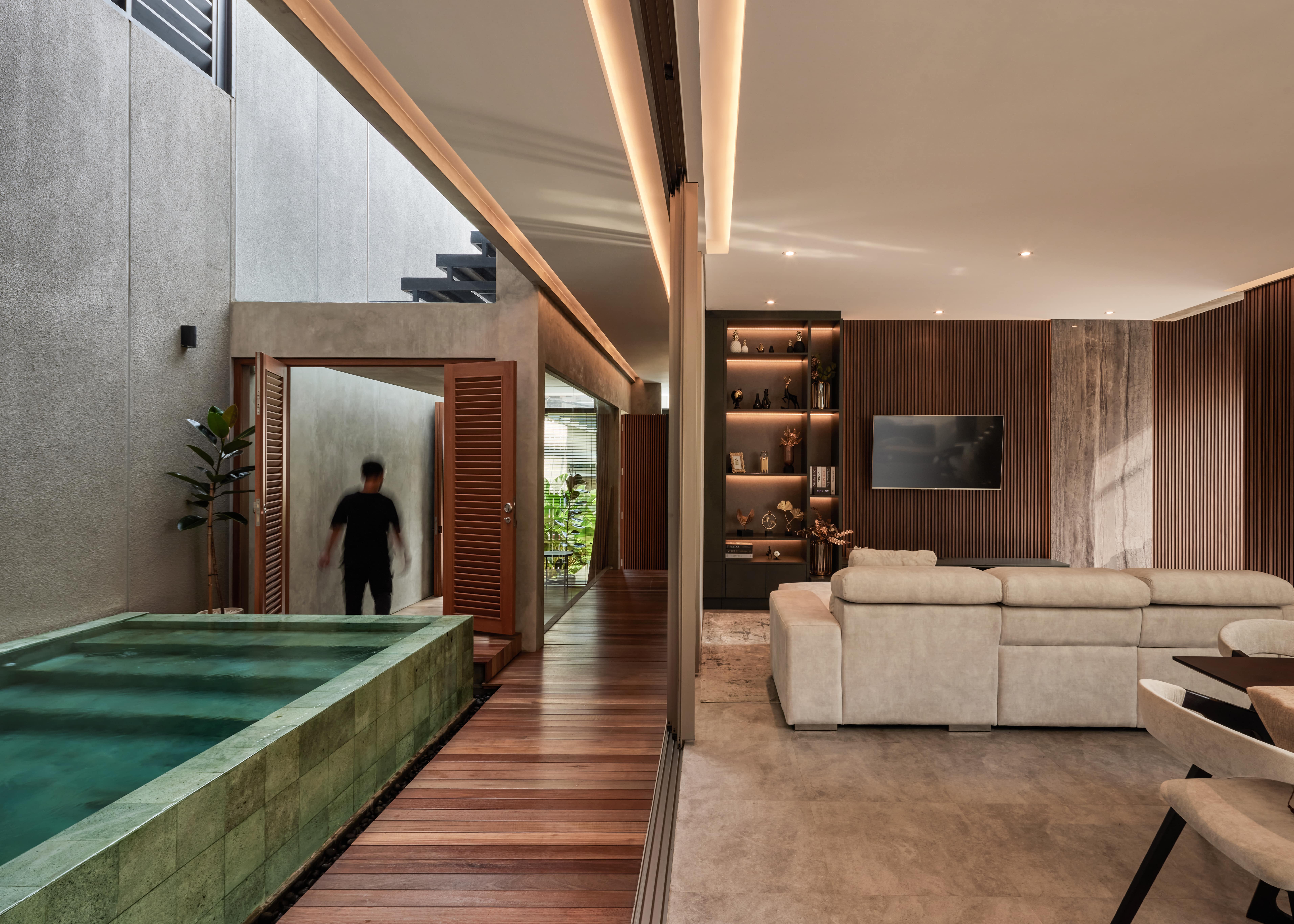 a public space featuring a living room side by side with a swimming pool