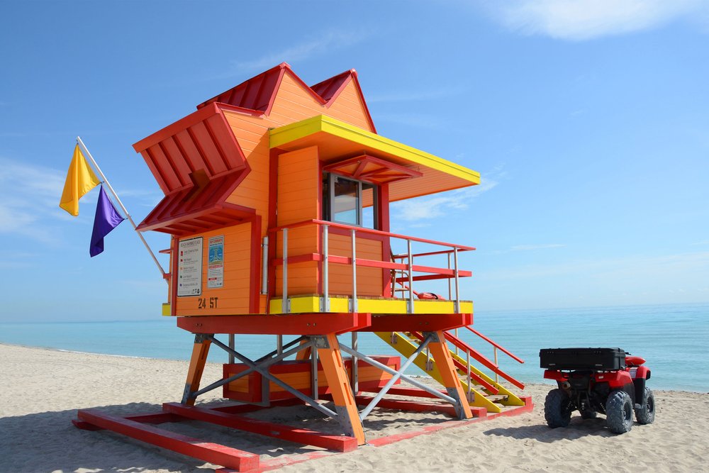 An eye-catching sight of Miami Beach is represented by a mix of blue seas and a lifeguard tower