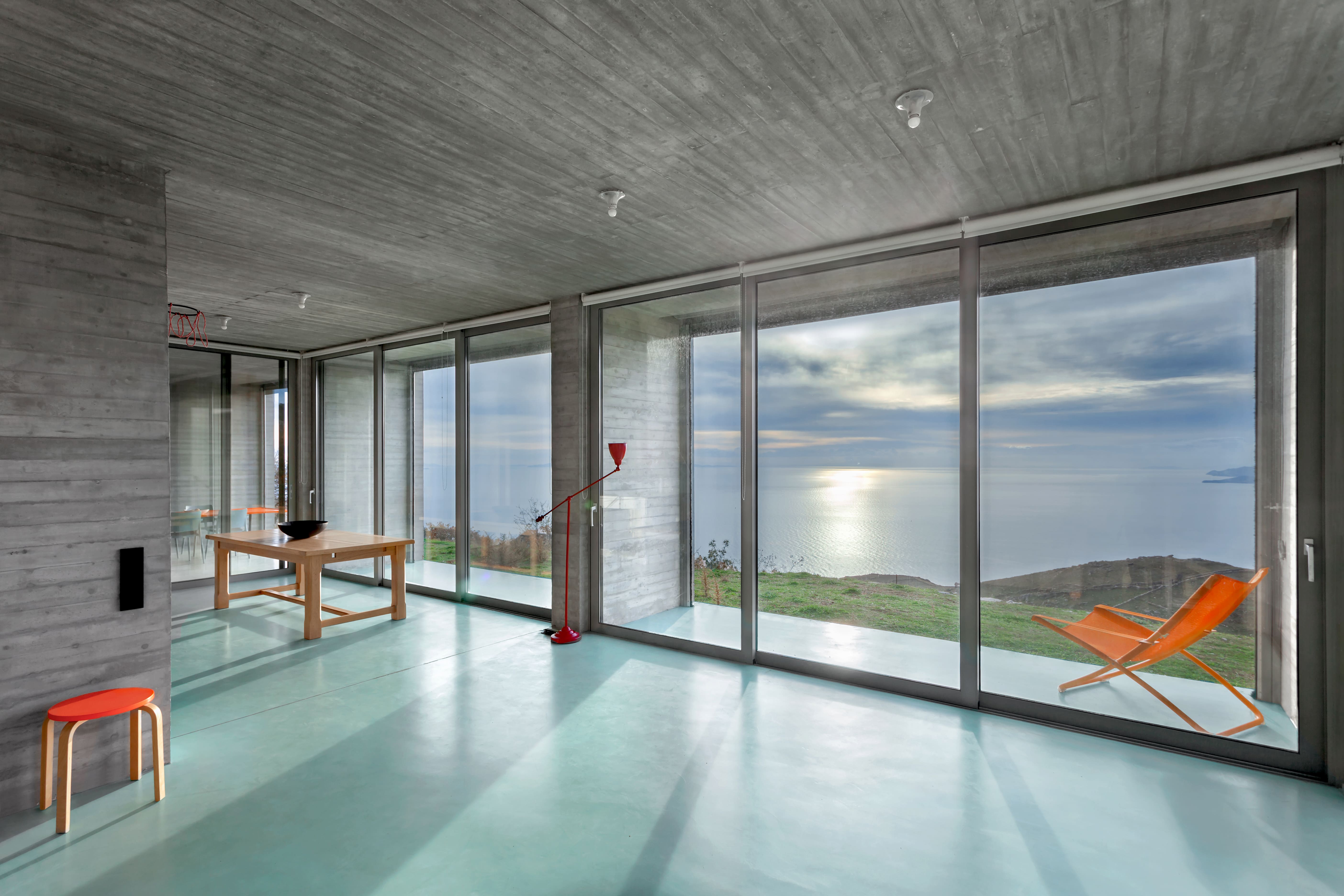 Windows stretch out at the front of the house to enjoy the sea and sky views