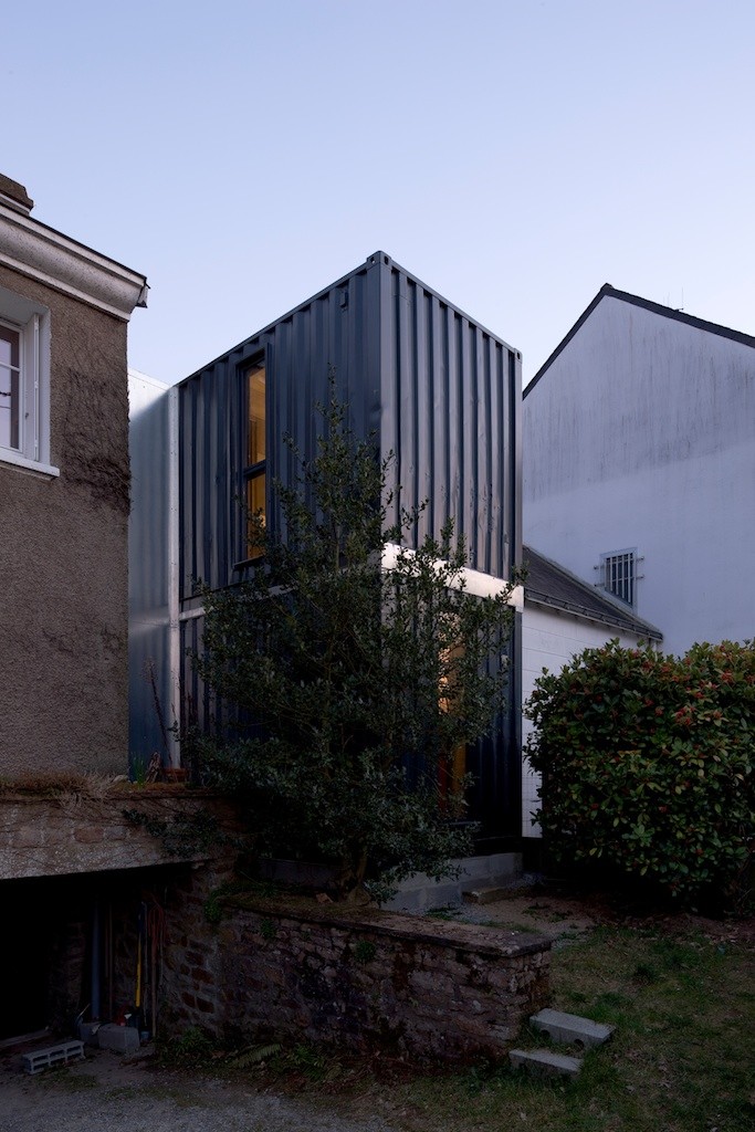 Maritime container facades appear in contrast to surrounding buildings